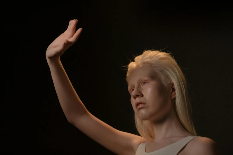 a woman holding her hand up in the air, a surrealist sculpture, inspired by Vanessa Beecroft, unsplash, hyperrealism, portrait of albino mystic, made of glowing wax and ceramic, realistic movie still, integrated synthetic android