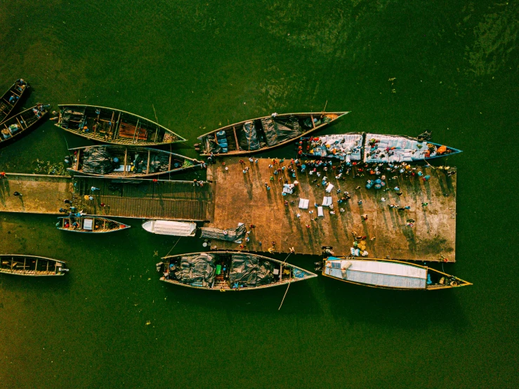 a group of boats sitting on top of a body of water, by Joseph Severn, pexels contest winner, hurufiyya, assamese aesthetic, flat lay, thumbnail, docks