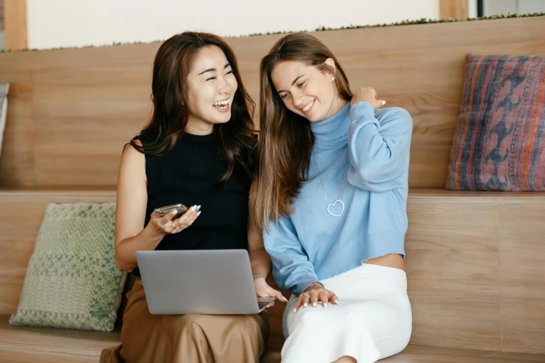 two women sitting on a couch looking at a laptop, trending on pexels, japanese collection product, wearing business casual dress, earing a shirt laughing, avatar image