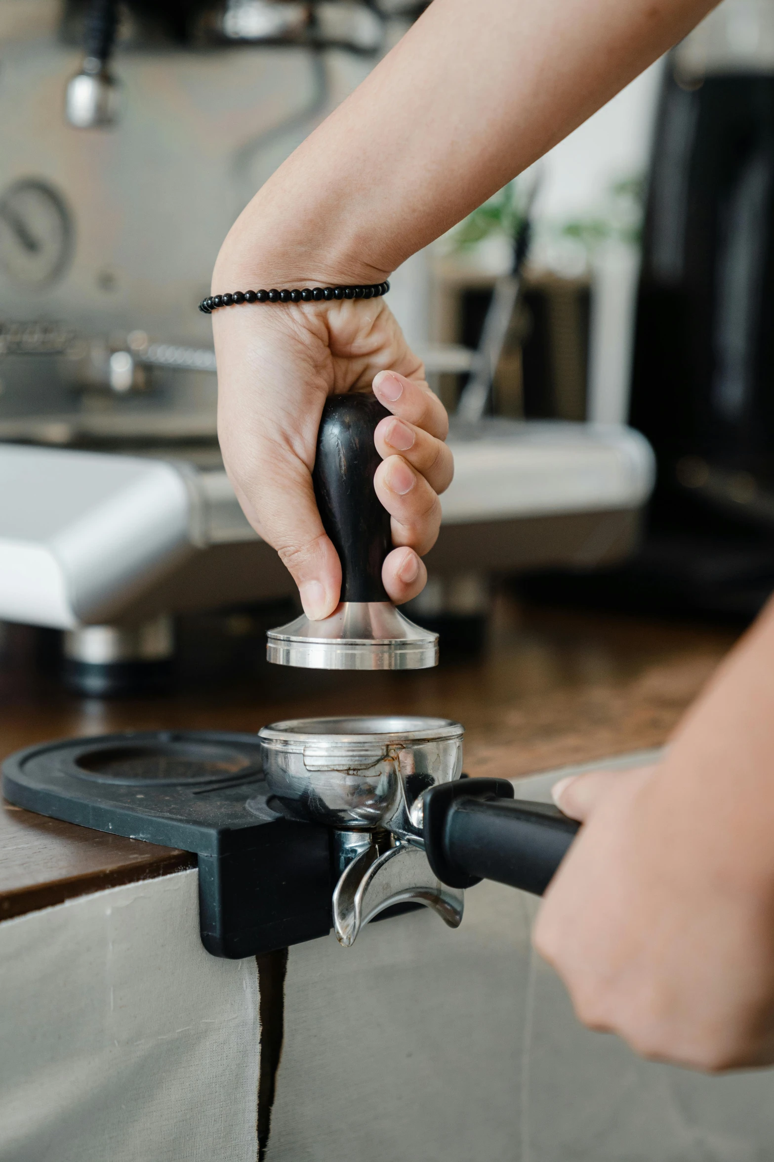 a person using a coffee grinder on a table, aussie baristas, thumbnail, spoon placed, detailed product image