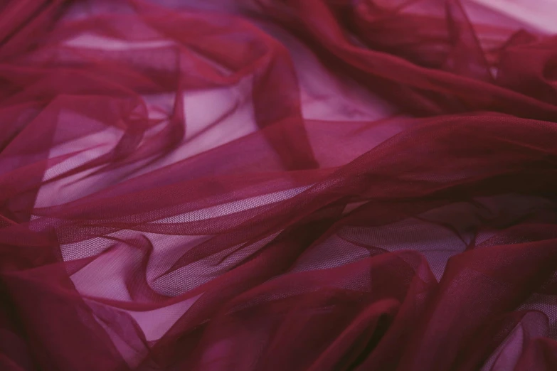 a close up of a red fabric on a bed, inspired by Anna Füssli, unsplash, deep purple veil, sheer fabrics, magenta colours, maroon red