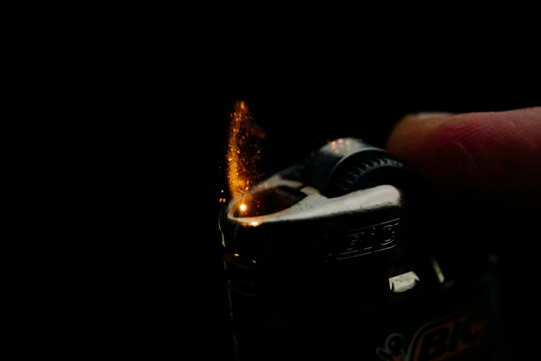 a person holding a lighter in their hand, by Adam Marczyński, pexels, hyperrealism, close up camera on bonfire level, medium format. soft light, glowing firebugs, miniature photography closeup