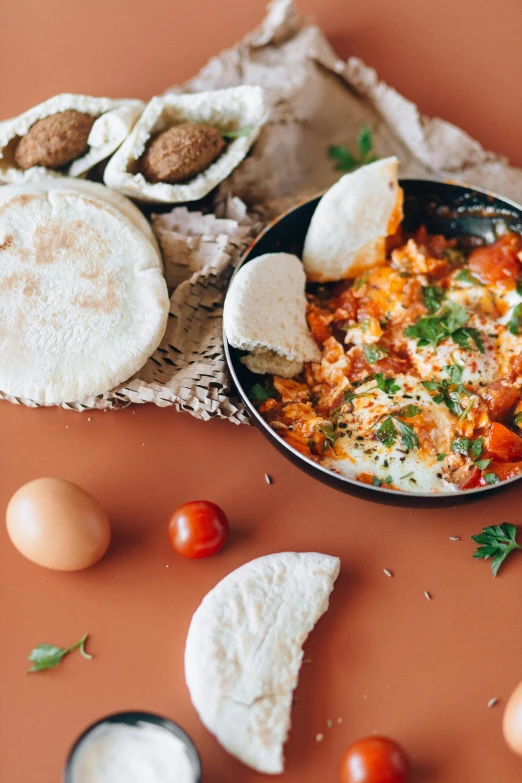 a pan filled with eggs sitting on top of a table, pexels contest winner, hurufiyya, arab inspired, humus, ❤🔥🍄🌪, breakfast