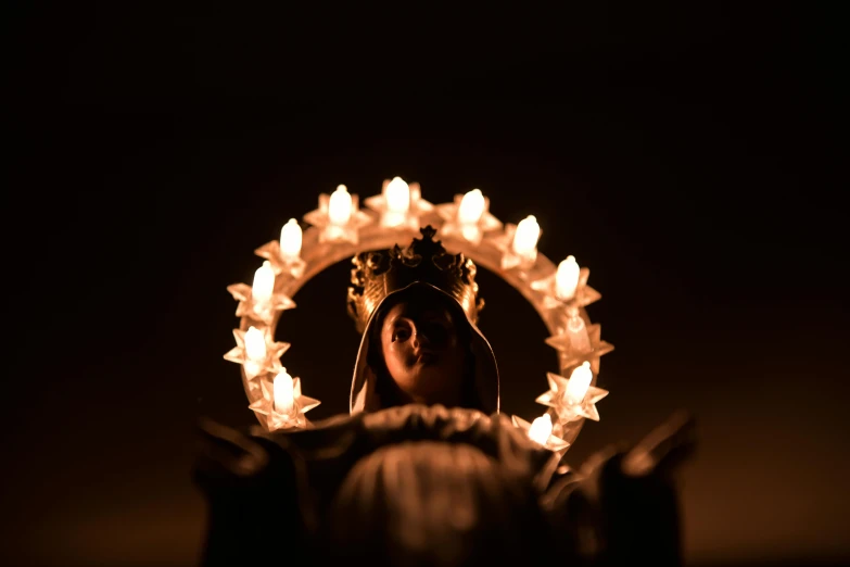 a woman that is standing in the dark, a statue, unsplash, baroque, ornate crystal crown hood, toy photography, virgin mary, icon with a halo of fire