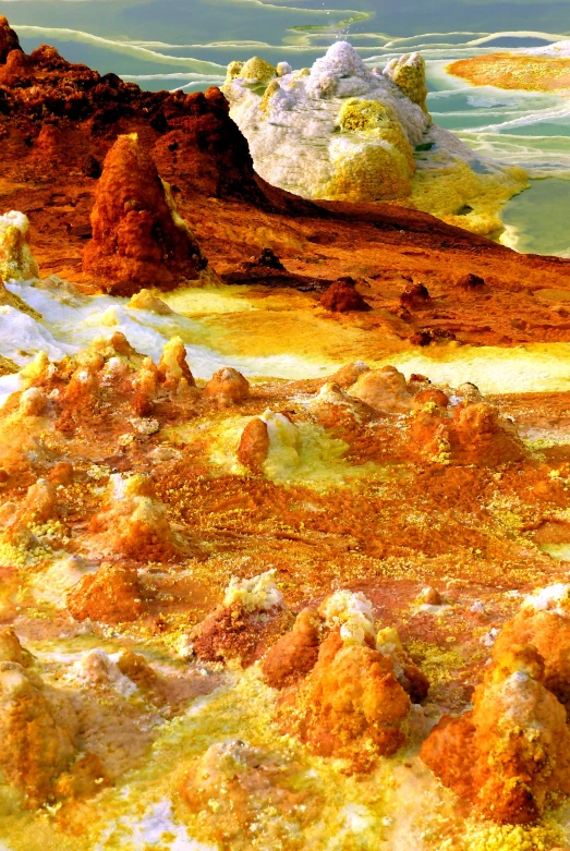 a close up of a desert with a mountain in the background, inspired by John Steuart Curry, process art, orange minerals, alien planet covered in water, white and yellow scheme, bubbling geysers