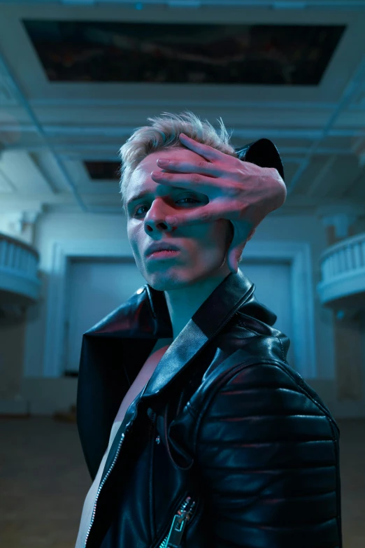 a man with a leather jacket covering his eyes, an album cover, inspired by Nikolaj Abraham Abildgaard, trending on pexels, photorealism, pale blue skin, attractive androgynous humanoid, still from a music video, vergil