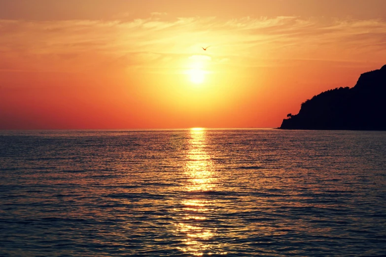 the sun is setting over a body of water, pexels contest winner, romanticism, cinq terre, fan favorite, brown, youtube thumbnail
