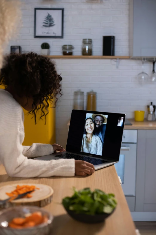 a woman sitting at a kitchen table with a laptop, pexels contest winner, hologram hovering around her, couple, photo of a black woman, long distance photo