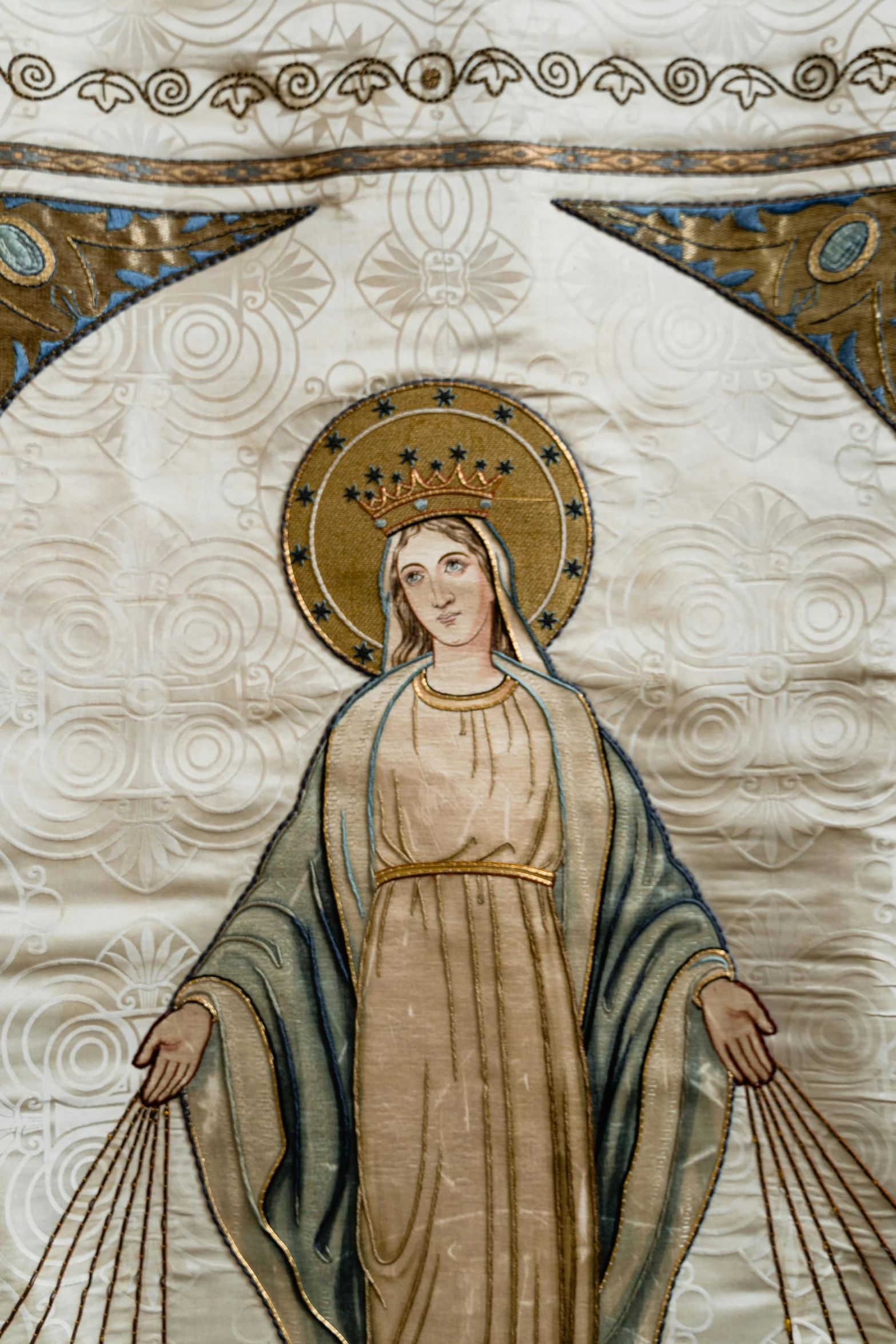 a close up of a painting on a wall, an album cover, inspired by Carlo Crivelli, shutterstock, cloisonnism, virgin mary, victorian textiles, early 2 0 th century, crown made of fabric