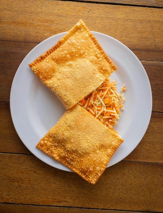 a close up of a plate of food on a table, product image, orange, italian, puffy