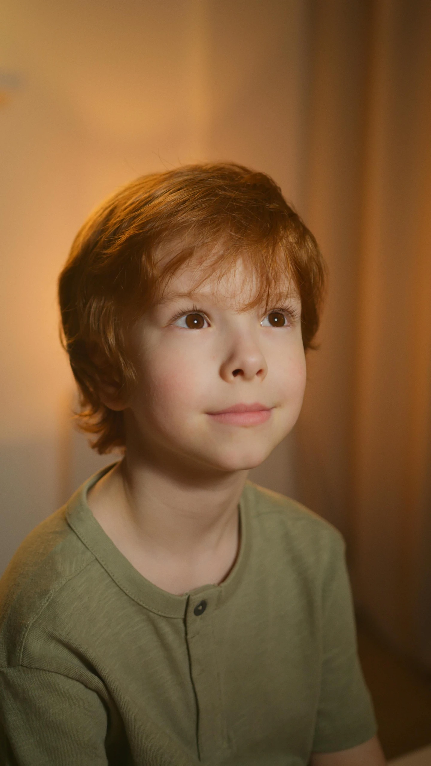 a young boy sitting in front of a laptop computer, by Daniel Seghers, pexels, photorealism, medium long wavy ginger hair, soft lighting 8k, thumbnail, lovingly looking at camera