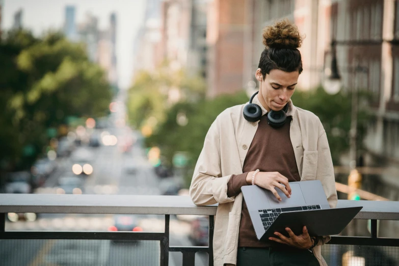 a woman standing on a bridge with a laptop, a portrait, by Carey Morris, trending on pexels, renaissance, man wearing a closed cowl, aboriginal australian hipster, overlooking a modern city, with head phones