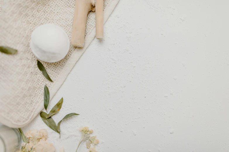 a couple of wooden spoons sitting on top of a table, soap, background image, white cloth, thumbnail