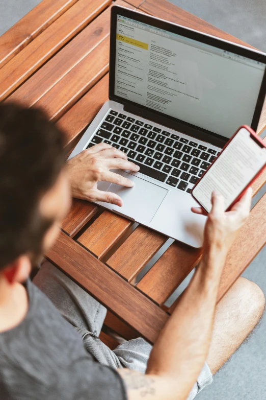 a man sitting on a bench using a laptop computer, by Dan Content, trending on pexels, renaissance, top down shot, 9 9 designs, excel running on the computer, carefully crafted