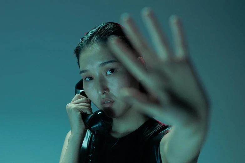 a close up of a person talking on a cell phone, inspired by Zhang Xiaogang, unsplash, hyperrealism, threatening pose, li bingbing, jaeyeon nam, waving at the camera