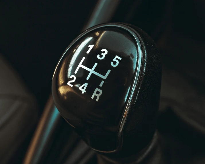 a close up of a gear stick in a car, trending on pexels, hyperrealism, header text”, close up shot of an amulet, black car, semi - realistic render