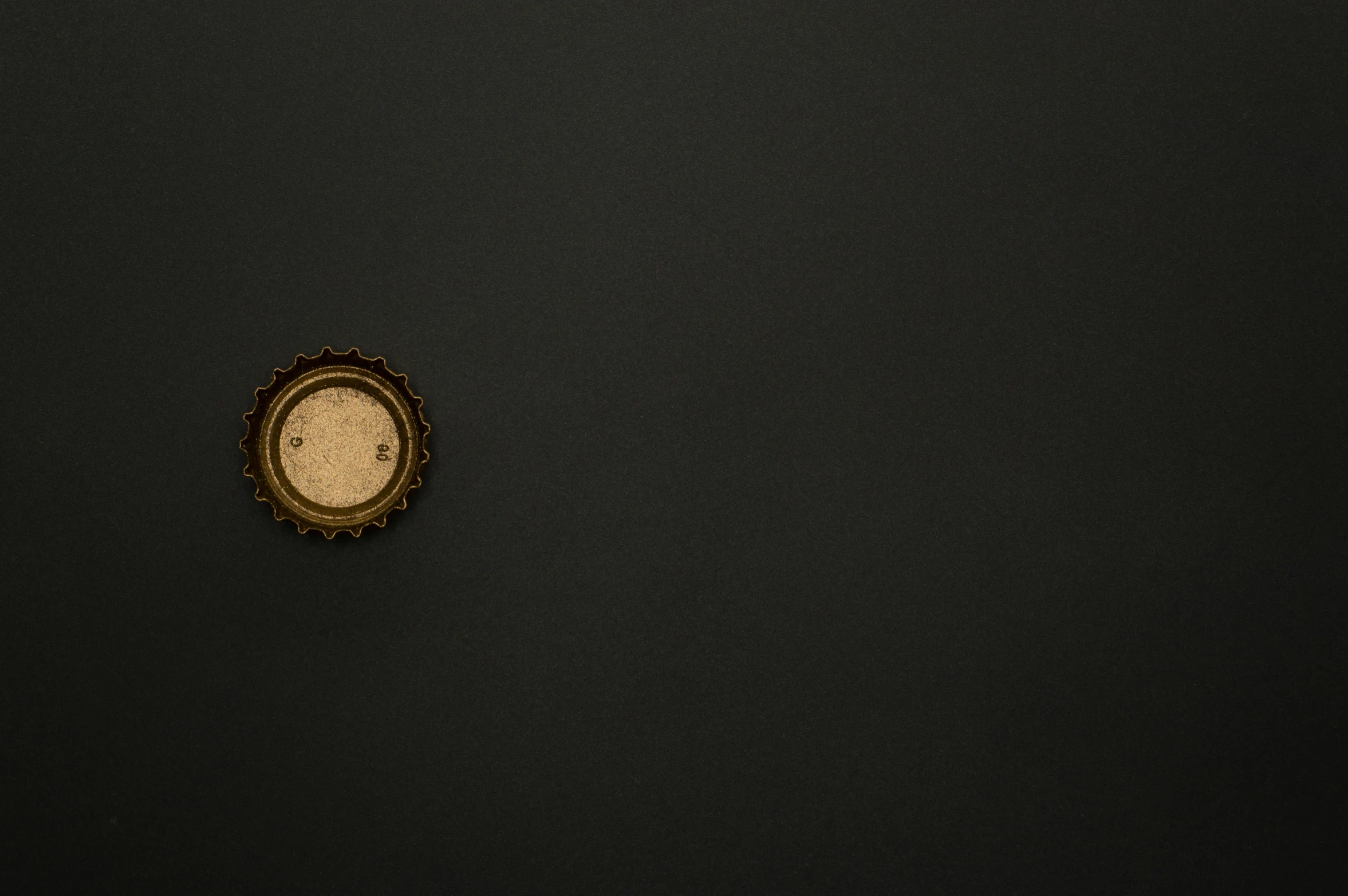 a clock sitting on top of a black wall, an album cover, by Adam Chmielowski, unsplash, conceptual art, surface with beer-texture, gold black, ffffound, black round hole