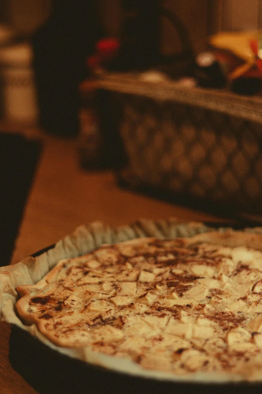 a pizza sitting on top of a pan on a table, a picture, inspired by Elsa Bleda, hurufiyya, sepia colors, chocolate, cosy, beige