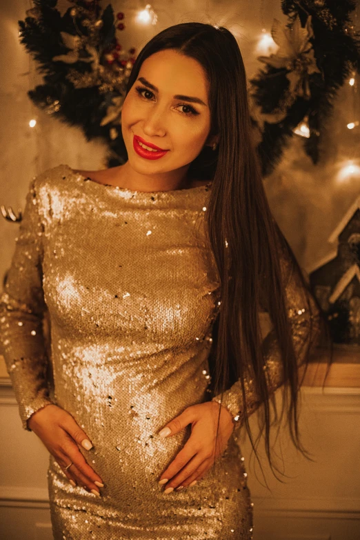 a woman in a gold dress posing for a picture, by Julia Pishtar, reddit, hurufiyya, sequin top, christmas night, 15081959 21121991 01012000 4k