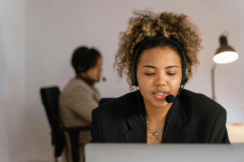 a woman sitting in front of a laptop wearing a headset, by Carey Morris, trending on pexels, hurufiyya, manuka, working in a call center, thumbnail, unedited