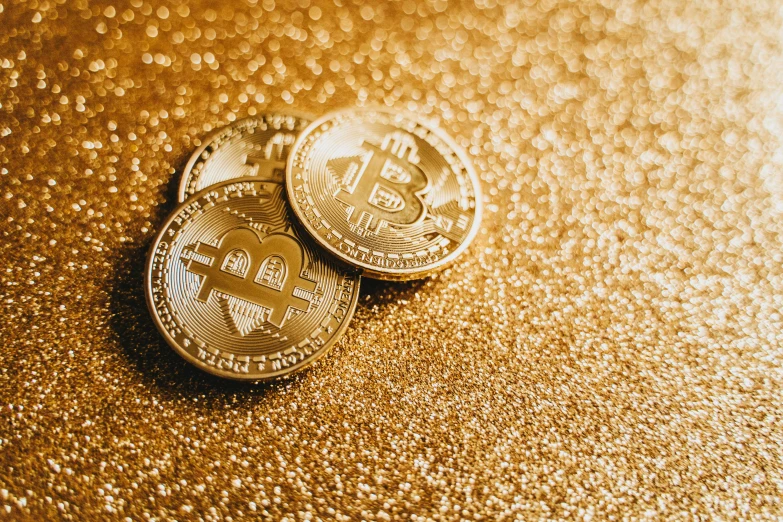 two gold bitcoins on a shiny surface, by Lena Alexander, trending on pixabay, renaissance, relaxed. gold background, background image