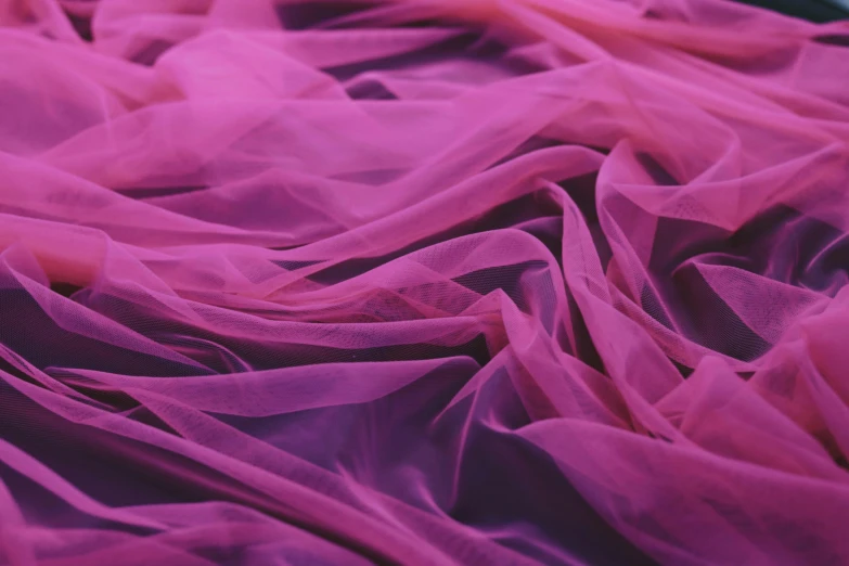 a close up of a purple cloth on a bed, inspired by Anna Füssli, trending on pexels, pink romantic tutu, magenta, translucent, textile