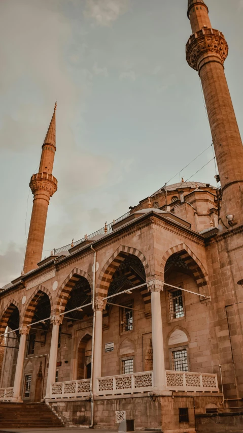 a large building with many pillars in front of it, by Ismail Acar, pexels contest winner, hurufiyya, lead - covered spire, 256x256, brown, navy