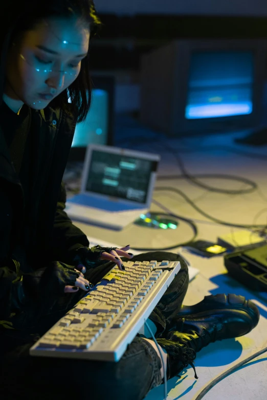 a woman sitting on the floor in front of a keyboard, inspired by Ai-Mitsu, underground lab, mixing, console and computer, performance