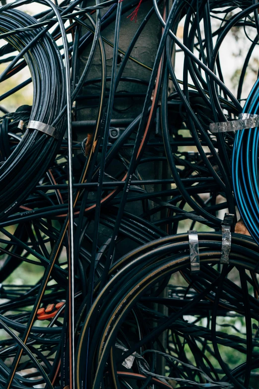 a bunch of wires are piled on top of each other, by Jesper Knudsen, unsplash, rubber hose style, carriage full of computers, carbon fibers, neighborhood