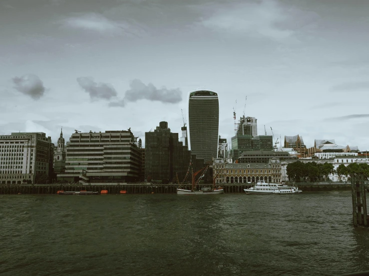 a large body of water with a city in the background, an album cover, inspired by Thomas Struth, pexels contest winner, brutalism, victorian london, grey, cinematic 4 k wallpaper, various sizes