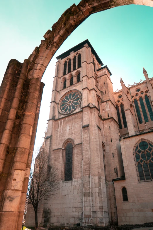 a tall building with a clock on the front of it, romanesque, cathedrals, arkane lyon, albuquerque, buttresses