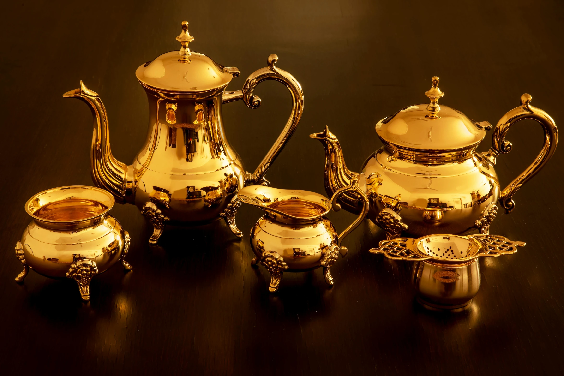 a silver tea set sitting on top of a table, gold plated, paul barson, metal kitchen utensils, thumbnail