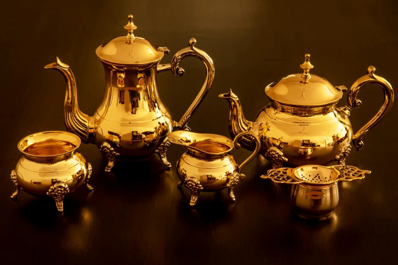 a silver tea set sitting on top of a table, gold plated, paul barson, metal kitchen utensils, thumbnail