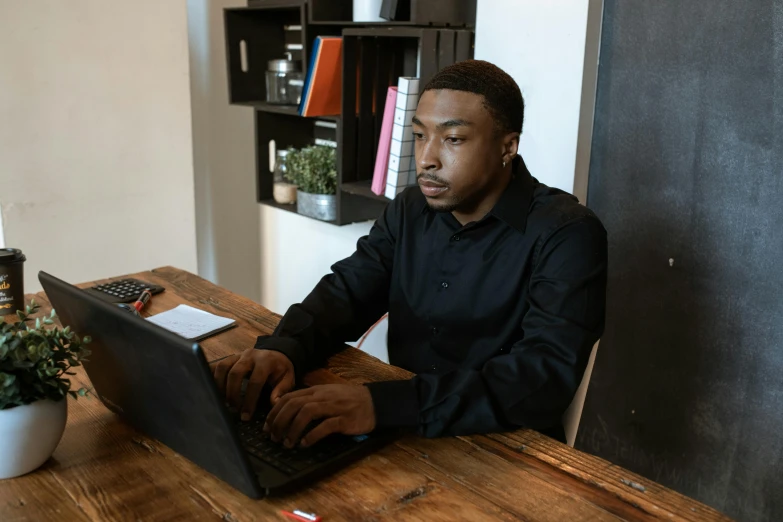 a man sitting at a table using a laptop computer, mkbhd, avatar image, multiple stories, abcdefghijklmnopqrstuvwxyz