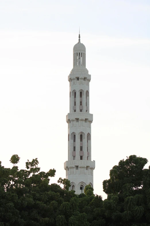 a tall tower with a clock on top of it, arabesque, oman, from wikipedia, elevation view, very long neck