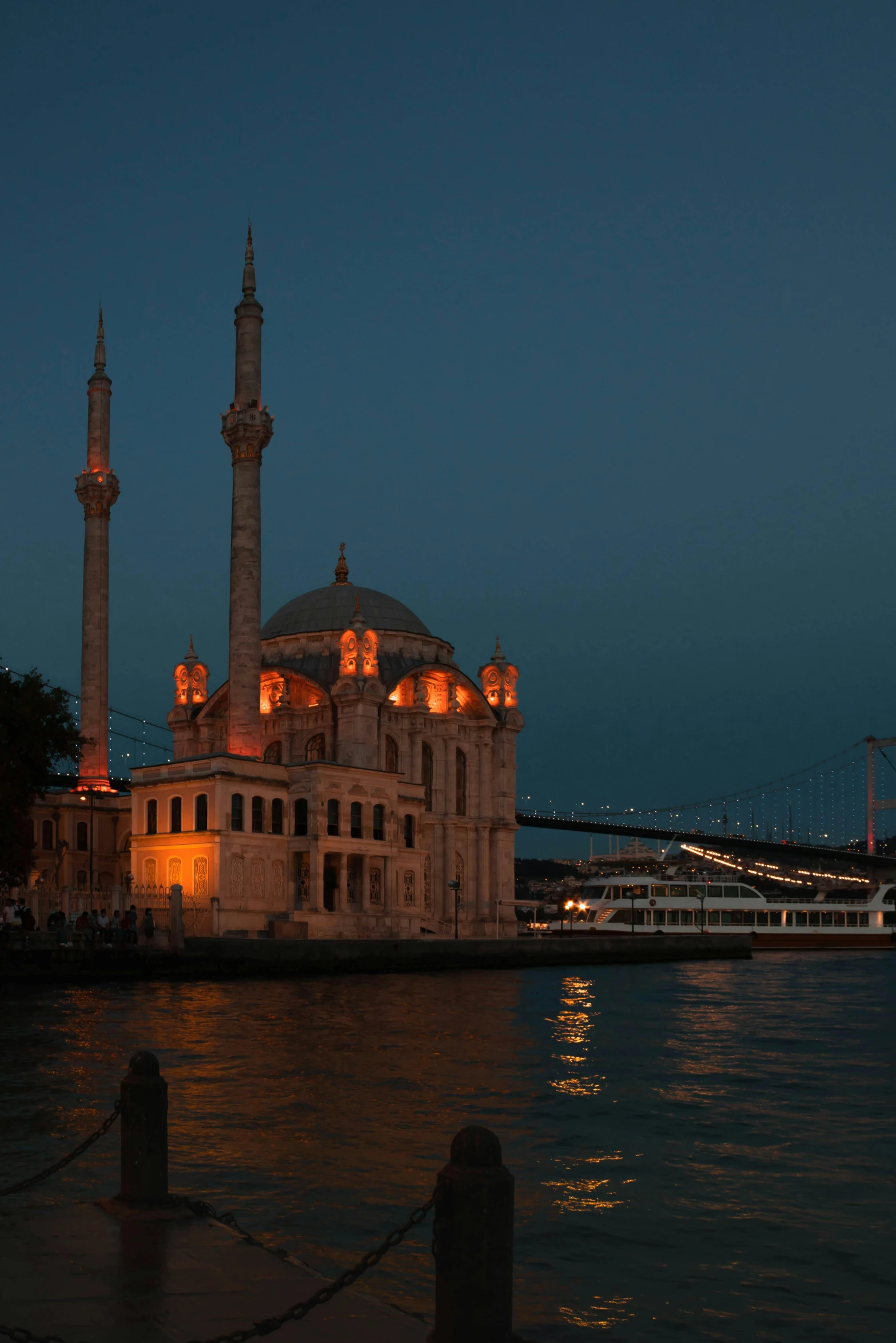 a large building sitting next to a body of water, inspired by Osman Hamdi Bey, nightlife, mosque, harbour, exterior