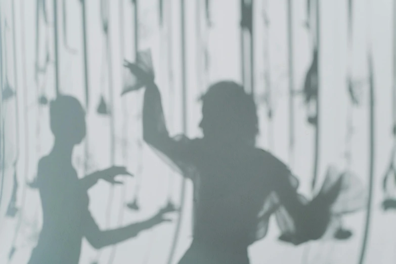 a couple of people that are standing in front of a wall, inspired by Anna Füssli, conceptual art, shadows of zombies, dance party, website banner, slightly out of focus