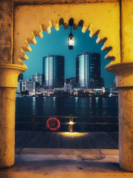 a view of a city through an archway, a colorized photo, pexels contest winner, arabian night, alexandria\'s genesis, profile image, karachi skyline background