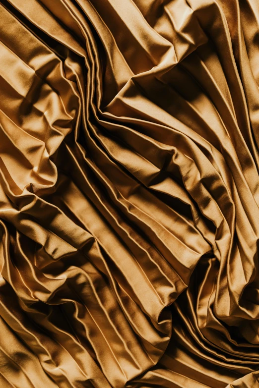 a close up of a brown silk fabric, an album cover, inspired by Christo, trending on pexels, baroque, sculpture made of gold, stylized dynamic folds, detailed product image, corduroy