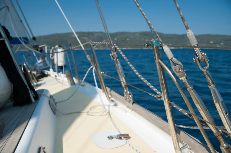 a close up of a sail boat on a body of water, overlooking the ocean, on a boat