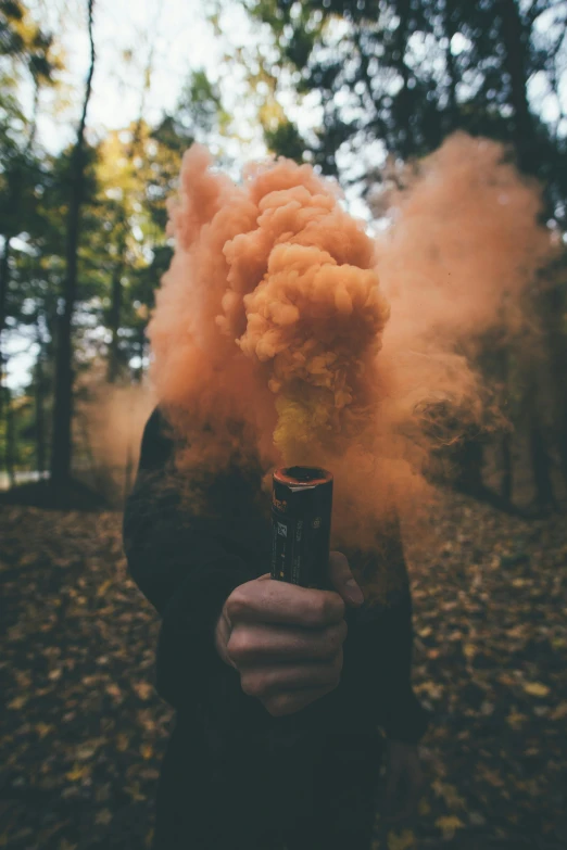 a person holding a bottle with smoke coming out of it, pexels contest winner, spooky autumnal colours, holding a rocket launcher, foam, high quality product image”