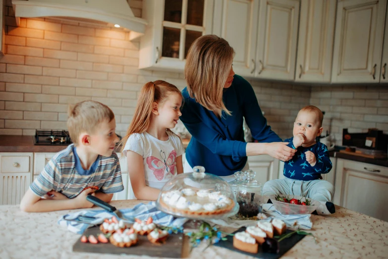 a woman and two children making cupcakes in a kitchen, by Emma Andijewska, pexels contest winner, avatar image, alexey gurylev, people at the table, high quality product image”