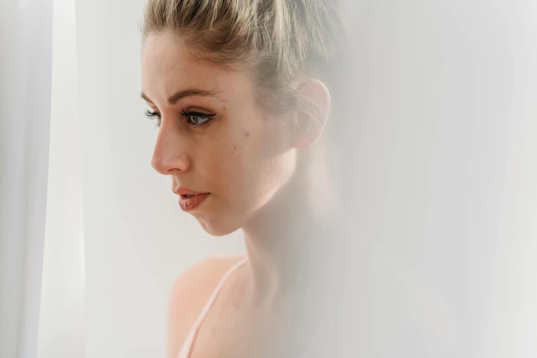 a beautiful young woman standing in front of a window, a character portrait, inspired by Elsa Bleda, trending on pexels, minimalism, clean face and body skin, sydney sweeney, portrait of a ballerina, emerging from the mist