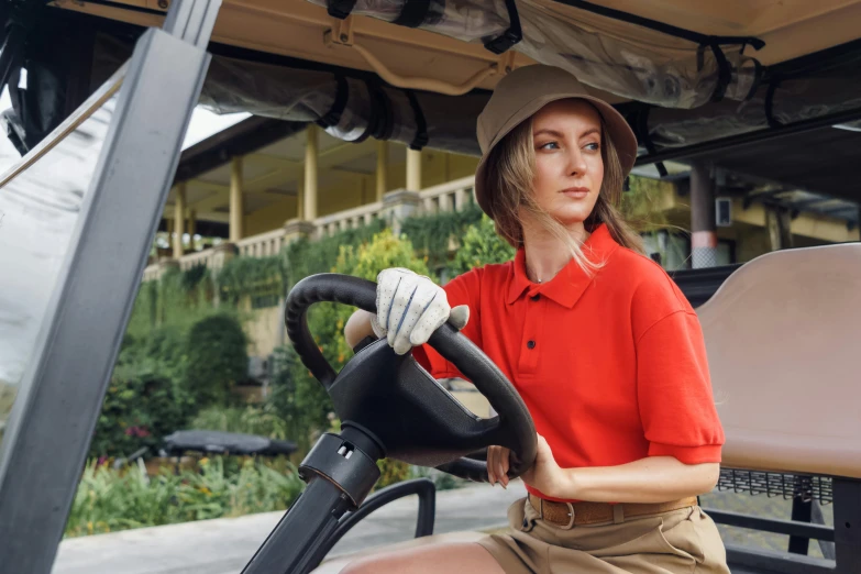 a woman sitting in the driver's seat of a golf cart, pexels contest winner, renaissance, wearing polo shirt, worksafe. instagram photo, wearing red attire, alana fletcher