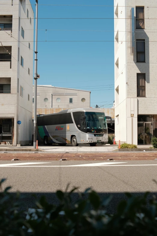 a bus is parked in front of a building, by Miyamoto, injured, full frame image, 🚿🗝📝, 4k)