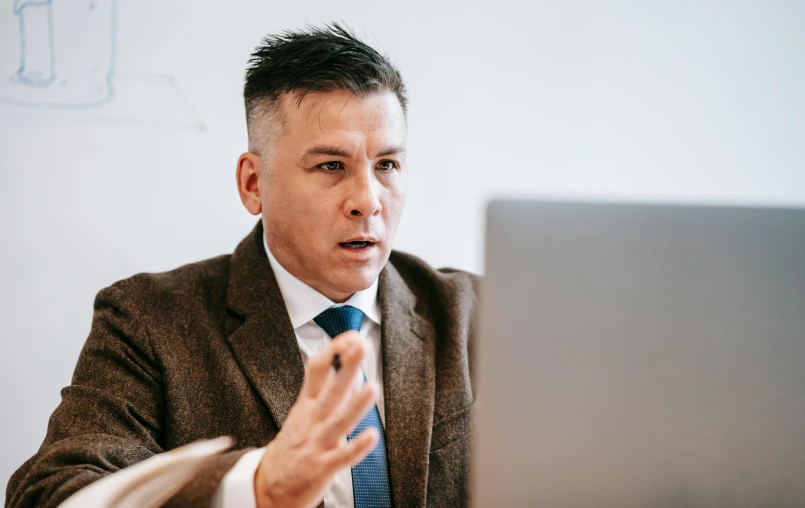 a man sitting in front of a laptop computer, unsplash, lawyer, till lindemann, lachlan bailey, liang mark