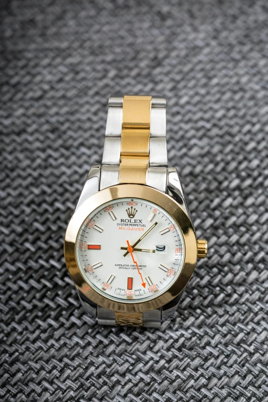 a close up of a watch on a table, a portrait, by Kev Walker, rolex, thumbnail, white with gold accents, white and orange