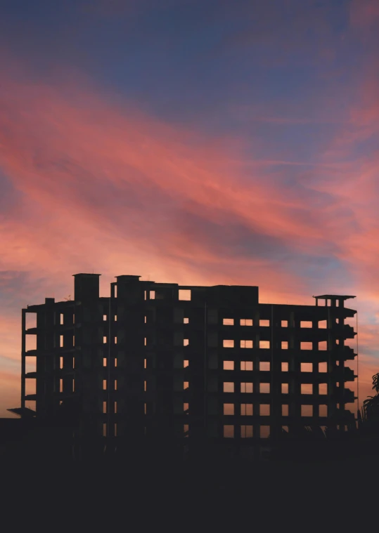 a tall building sitting on top of a lush green field, an album cover, pexels contest winner, brutalism, ((sunset)), mass housing, college, goodnight
