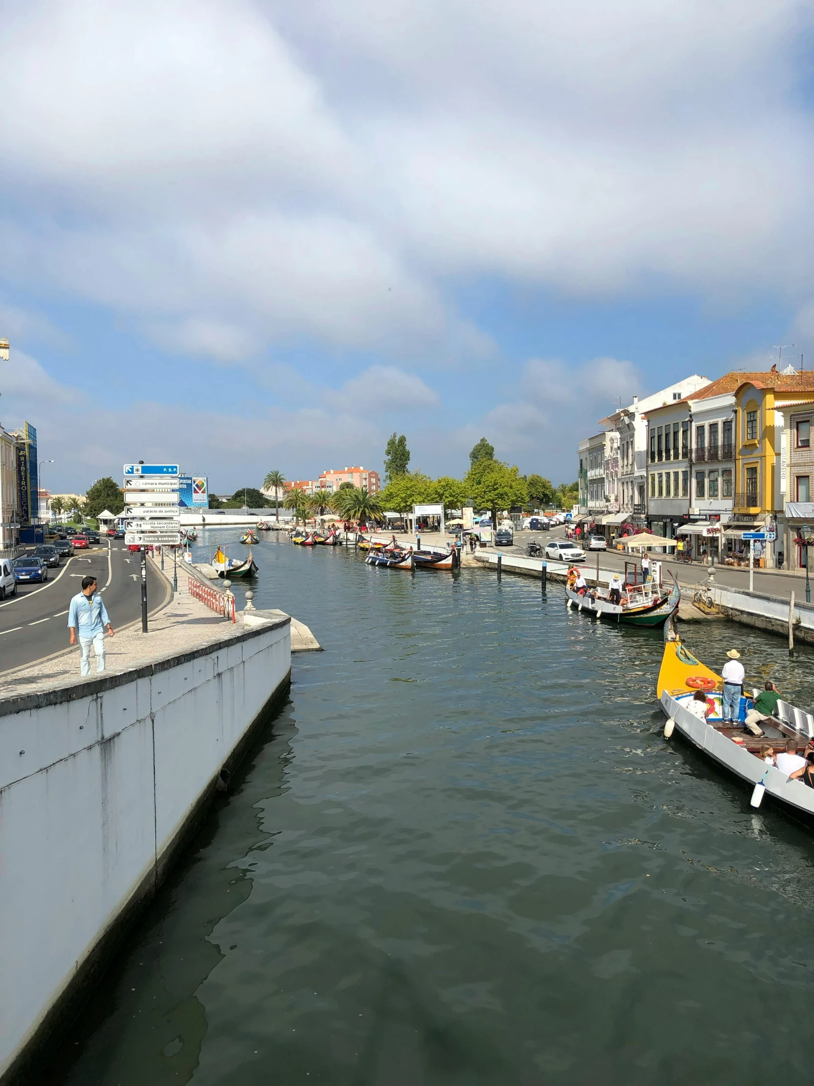 a river filled with lots of boats next to tall buildings, inspired by Almada Negreiros, happening, slide show, thumbnail, tourist destination, 2022 photograph