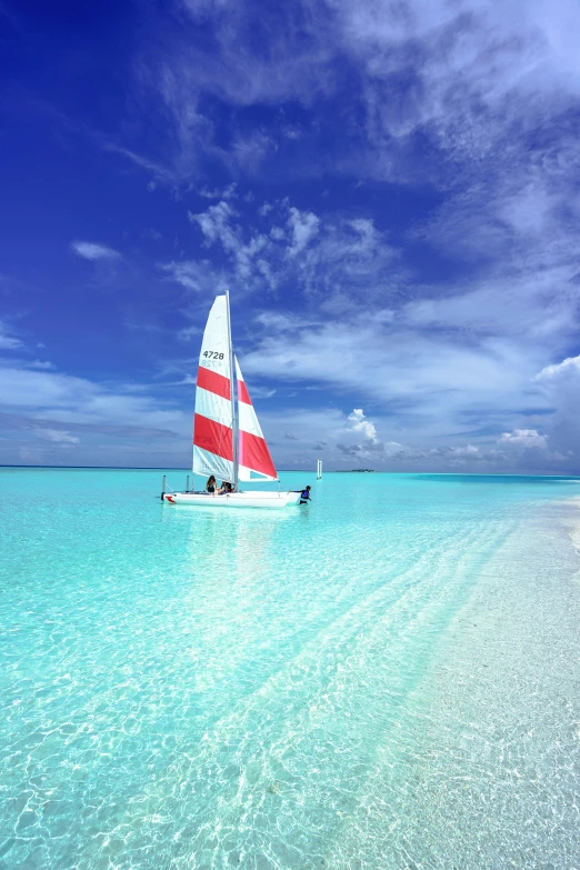 a sailboat floating on top of a body of water, white beaches, beachfront, square, ben nicholas